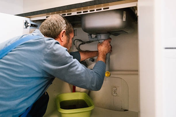 Master plumber installing new construction bathroom rough-in piping