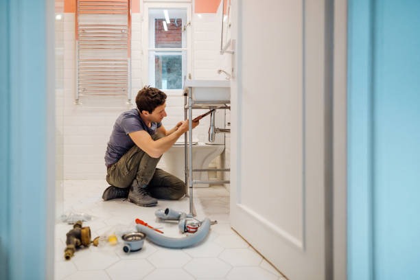 Master plumber installing luxury kitchen pull-down faucet
